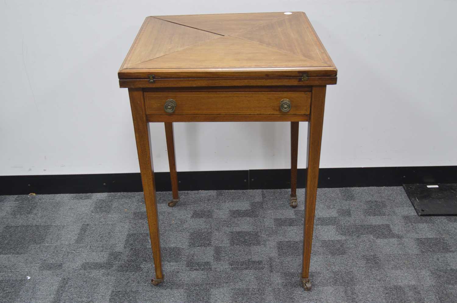 Lot 59 - An Edwardian mahogany envelope games or card table