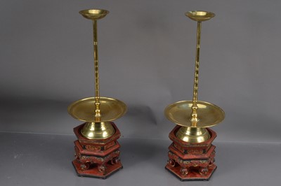 Lot 352 - A pair of 19th Century Chinese brass candlesticks with lacquered hardwood stands