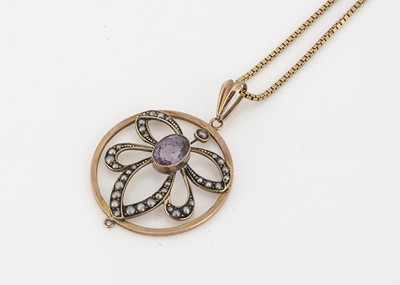 Lot 54 - An Edwardian 9ct gold amethyst and seed pearl drop openwork pendant