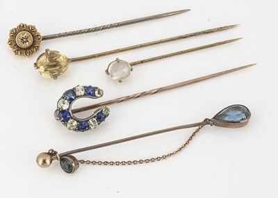 Lot 83 - Five gem set yellow metal stick pins