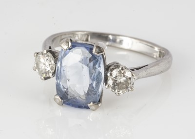 Lot 90 - An 18ct white gold sapphire and diamond three stone ring