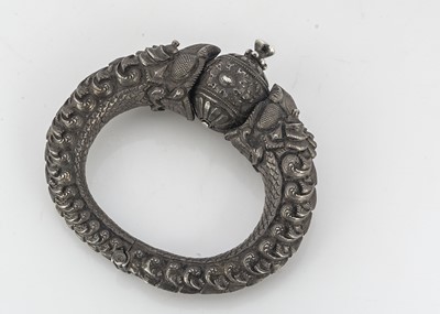 Lot 339 - An Indian white metal Makara hinged bangle