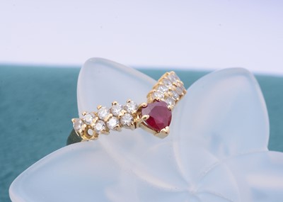 Lot 265 - A continental 750 marked ruby and diamond wishbone ring