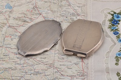 Lot 442 - Two silver oval shaped compacts