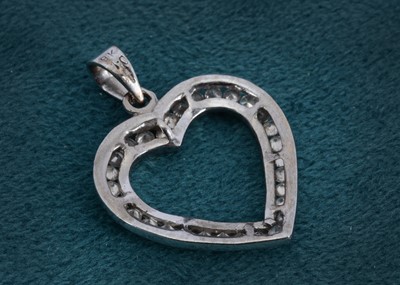 Lot 11 - A 9ct white gold and diamond set open heart pendant