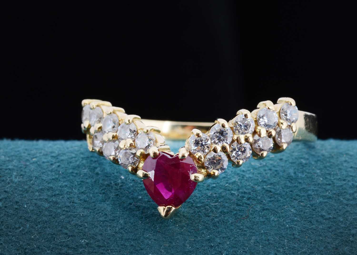 Lot 22 - A continental 750 marked ruby and cubic zirconia wishbone ring