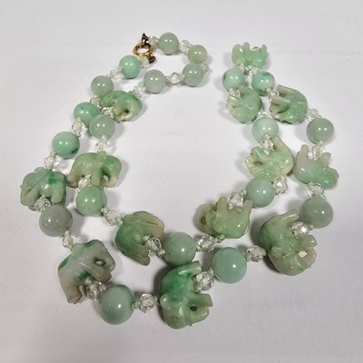 Lot 55 - A string of jadeite jade and boneite beads