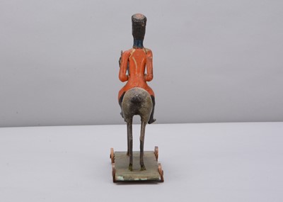 Lot 76 - A mid 19th century Thüringen composition and wood British mounted soldier pull along toy