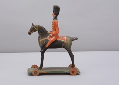 Lot 76 - A mid 19th century Thüringen composition and wood British mounted soldier pull along toy