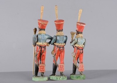 Lot 105 - Four mid 19th century wooden Hussar bandsmen
