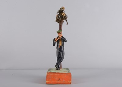Lot 175 - An 1830s Sonneberg papier-mâché and wood hand-cranked mechanical toy of a student playing a flute