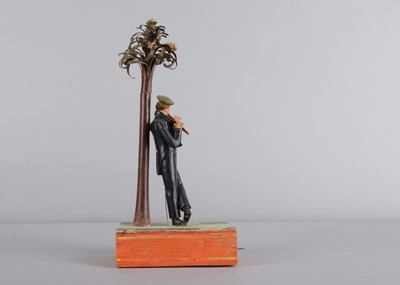 Lot 175 - An 1830s Sonneberg papier-mâché and wood hand-cranked mechanical toy of a student playing a flute