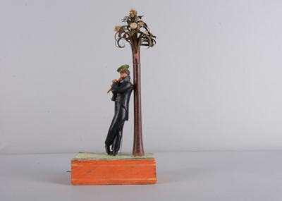 Lot 175 - An 1830s Sonneberg papier-mâché and wood hand-cranked mechanical toy of a student playing a flute
