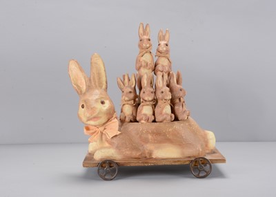 Lot 240 - A set of Bethany Lowe's papier-mâché rabbit skittles in rabbit on wheeled holder