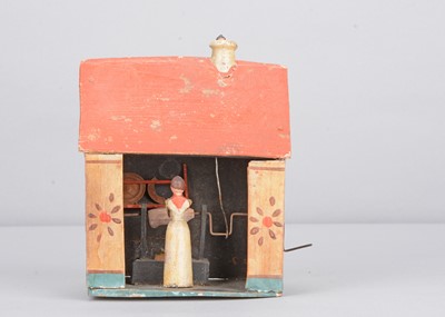 Lot 267 - A 19th century Erzgebirge painted wooden kitchen house crank toy