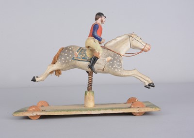 Lot 359 - A mid 19th century Thüringen composition jockey riding grey horse pull along toy