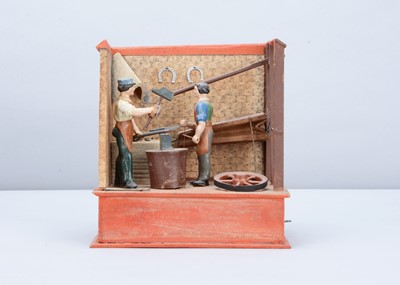 Lot 376 - A mid 19th century Thüringen papier-mâché and wood blacksmith’s forge mechanical toy