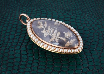 Lot 2 - An 18th Century navette shaped seed pearl and white enamel mourning pendant