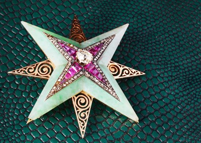 Lot 16 - An art deco jadeite jade, ruby and diamond star brooch