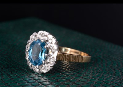 Lot 61 - A 9ct gold topaz and diamond oval cluster ring