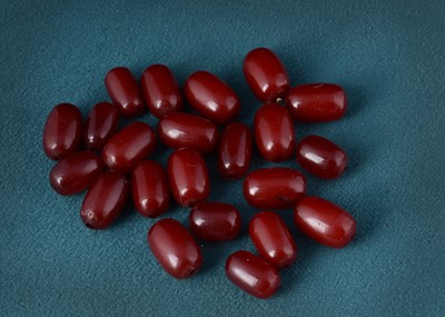 Lot 63 - A collection of 'cherry amber' oval beads