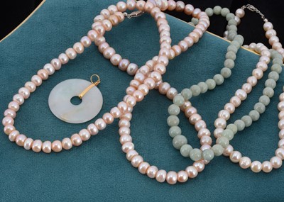 Lot 77 - A Chinese Jade Disc pendant, with a yellow metal mount