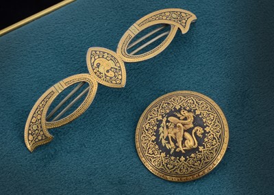 Lot 79 - An early 20th century Asian damascene circular brooch cantered with a winged dragon clutching a leafed branch in one claw 