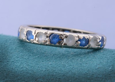 Lot 101 - A white 18ct gold sapphire and colourless paste eternity ring