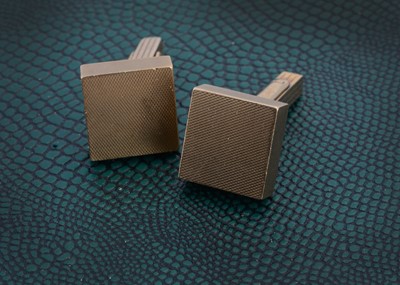 Lot 137 - A pair of 9ct gold engine turned cufflinks