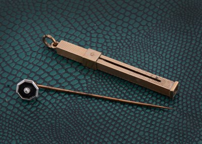 Lot 146 - A 9ct gold engine turned toothpick fob