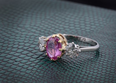Lot 148 - A three stone sapphire and diamond dress ring