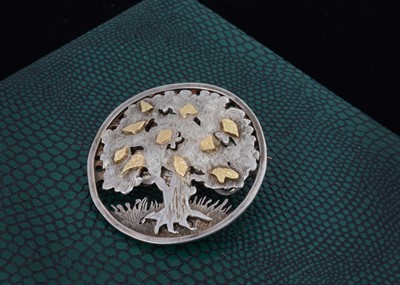 Lot 164 - A contemporary silver and gold tree of life circular brooch