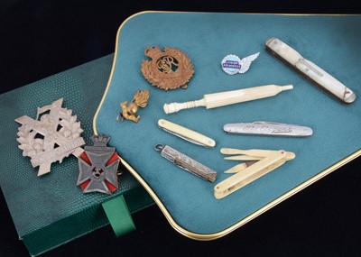 Lot 183 - A small quantity of cap badges and bone souvenirware