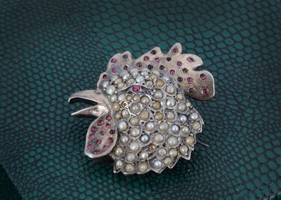 Lot 192 - A silver seed pearl and ruby and garnet set brooch
