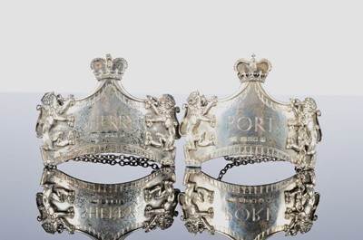 Lot 239 - A pair of 1970s silver decanter labels by LGD