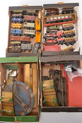 Lot 493 - Hornby pre and post war 0 Gauge clockwork mostly unboxed Locomotives Coaches Goods Rolling Stock Stations Accessories and Track (qty)