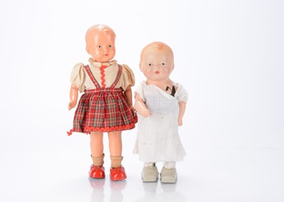 Lot 477 - Two clockwork walking dolls