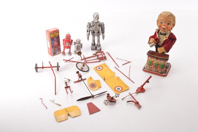Lot 631 - TN Toys Japan Battery Operated Charlie Weaver Bartender modern clockwork Robots and a broken (in parts) novelty early style peddle powered Monoplane (5)