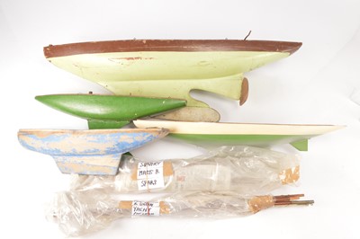 Lot 665 - Four large vintage wooden Pond Yacht Hulls in various conditions (4 plus spares)