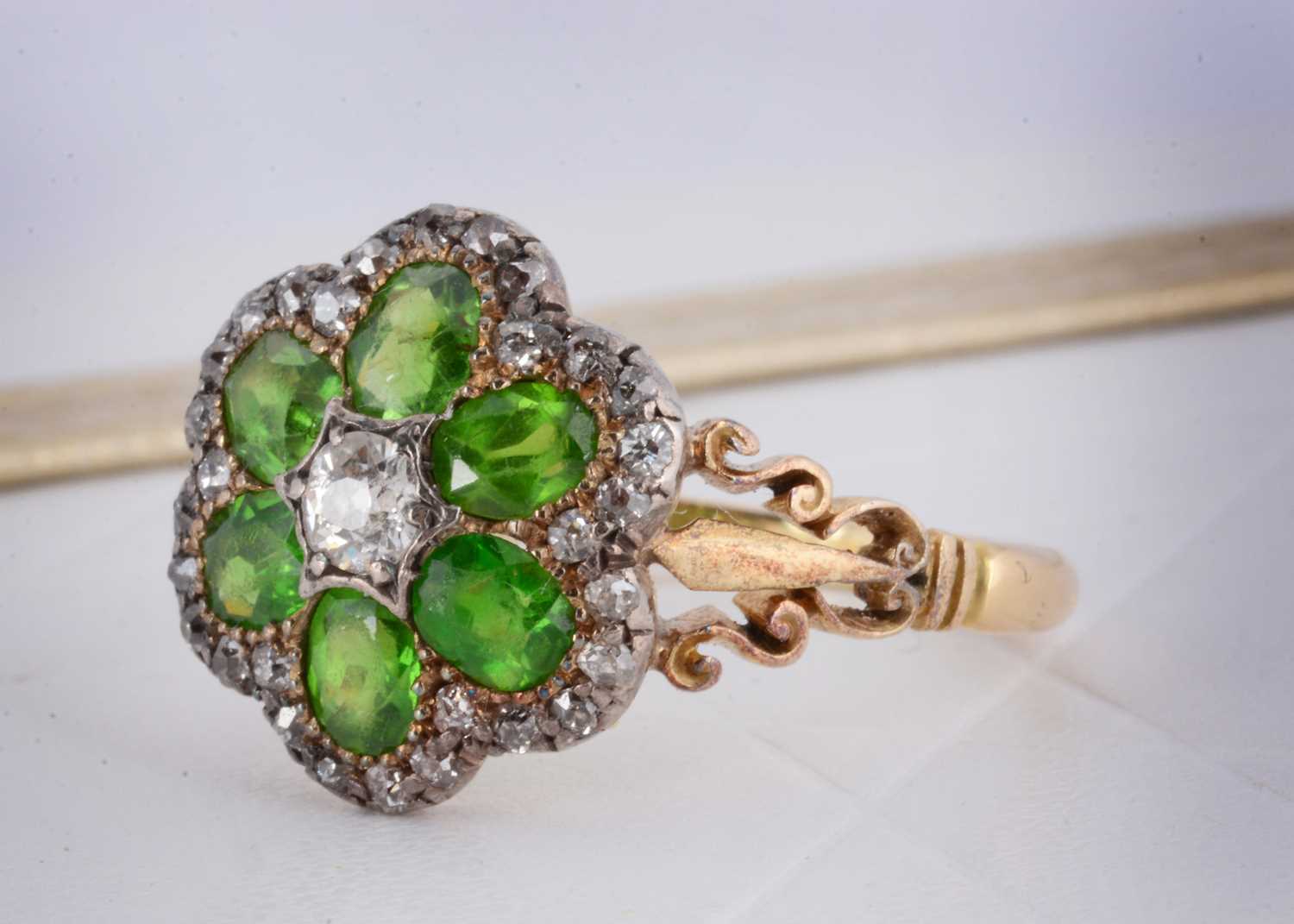 Lot 2 - An Edwardian diamond and demantoid garnet cluster ring