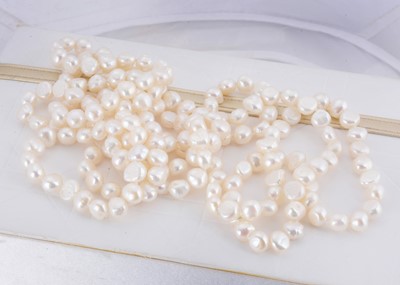 Lot 29 - An opera length string of freshwater knotted pearls