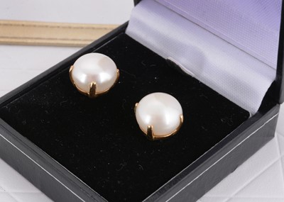 Lot 32 - A pair of 18ct gold and large button pearl studs