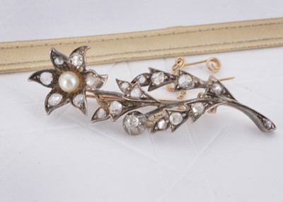 Lot 37 - An Edwardian diamond and pearl set flower head and stem brooch