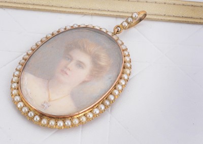 Lot 43 - An Edwardian gold and seed pearl framed ivory miniature