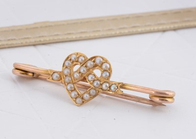 Lot 59 - An Edwardian seed pearl safety pin bar brooch