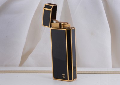 Lot 82 - A gold plated and black enamel rectangular Cartier pocket lighter