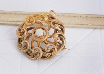 Lot 116 - An Edwardian openwork circular scroll target brooch or pendant