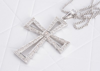 Lot 124 - A contemporary 9ct white gold and diamond set cross pendant