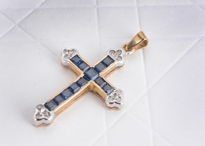 Lot 128 - A 9ct gold sapphire and diamond set cross pendant