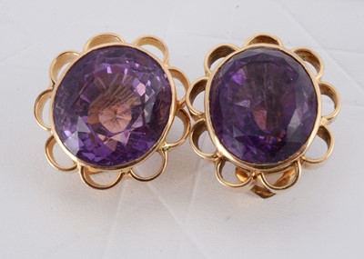 Lot 148 - A pair of yellow metal 750 marked amethyst clip earrings